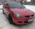 Красный Мицубиси Лансер, объемом двигателя 2 л и пробегом 248 тыс. км за 3203 $, фото 1 на Automoto.ua