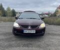 Красный Мицубиси Лансер, объемом двигателя 2 л и пробегом 295 тыс. км за 4150 $, фото 1 на Automoto.ua