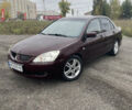Червоний Міцубісі Lancer, об'ємом двигуна 2 л та пробігом 295 тис. км за 4150 $, фото 1 на Automoto.ua