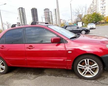 Красный Мицубиси Лансер, объемом двигателя 2 л и пробегом 320 тыс. км за 4600 $, фото 1 на Automoto.ua