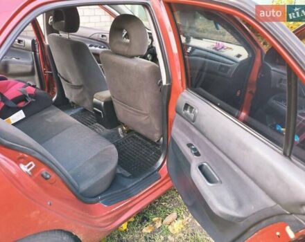 Красный Мицубиси Лансер, объемом двигателя 1.6 л и пробегом 214 тыс. км за 5000 $, фото 5 на Automoto.ua