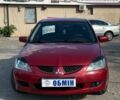 Красный Мицубиси Лансер, объемом двигателя 1.6 л и пробегом 230 тыс. км за 5300 $, фото 1 на Automoto.ua