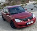 Красный Мицубиси Лансер, объемом двигателя 1.6 л и пробегом 242 тыс. км за 4999 $, фото 1 на Automoto.ua