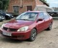 Красный Мицубиси Лансер, объемом двигателя 1.6 л и пробегом 210 тыс. км за 1701 $, фото 1 на Automoto.ua