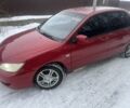 Красный Мицубиси Лансер, объемом двигателя 1.6 л и пробегом 229 тыс. км за 1652 $, фото 1 на Automoto.ua