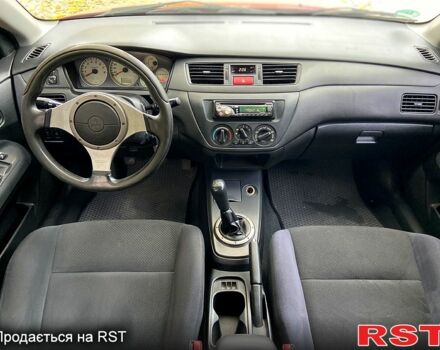 Красный Мицубиси Лансер, объемом двигателя 1.6 л и пробегом 214 тыс. км за 3999 $, фото 9 на Automoto.ua