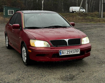 Красный Мицубиси Лансер, объемом двигателя 2 л и пробегом 202 тыс. км за 2599 $, фото 1 на Automoto.ua