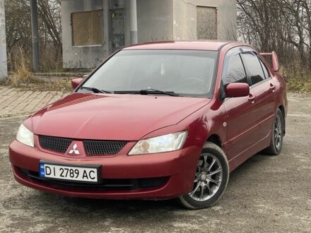 Красный Мицубиси Лансер, объемом двигателя 1.6 л и пробегом 186 тыс. км за 4000 $, фото 1 на Automoto.ua