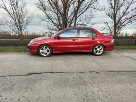 Красный Мицубиси Лансер, объемом двигателя 2 л и пробегом 280 тыс. км за 4500 $, фото 1 на Automoto.ua