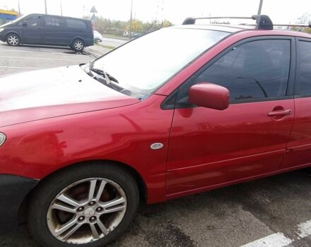 Красный Мицубиси Лансер, объемом двигателя 2 л и пробегом 320 тыс. км за 4600 $, фото 1 на Automoto.ua