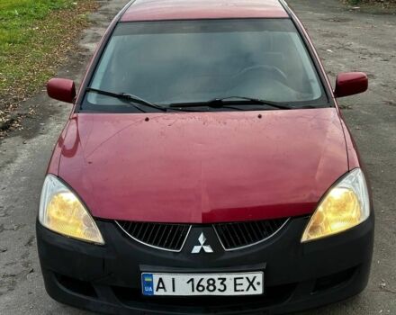 Красный Мицубиси Лансер, объемом двигателя 1.6 л и пробегом 290 тыс. км за 2800 $, фото 1 на Automoto.ua
