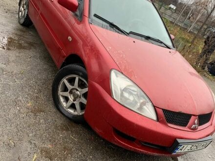 Красный Мицубиси Лансер, объемом двигателя 1.6 л и пробегом 300 тыс. км за 2799 $, фото 1 на Automoto.ua