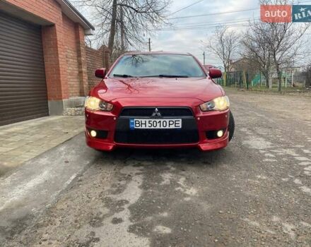 Красный Мицубиси Лансер, объемом двигателя 2 л и пробегом 66 тыс. км за 10000 $, фото 1 на Automoto.ua