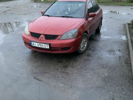 Красный Мицубиси Лансер, объемом двигателя 1.6 л и пробегом 230 тыс. км за 3000 $, фото 1 на Automoto.ua
