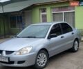 Серый Мицубиси Лансер, объемом двигателя 1.6 л и пробегом 230 тыс. км за 3100 $, фото 1 на Automoto.ua