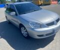 Серый Мицубиси Лансер, объемом двигателя 1.58 л и пробегом 185 тыс. км за 4499 $, фото 1 на Automoto.ua