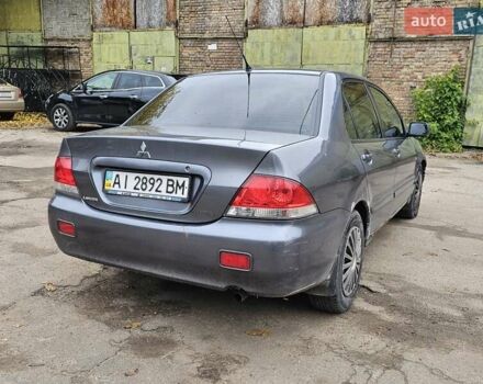 Сірий Міцубісі Lancer, об'ємом двигуна 1.58 л та пробігом 200 тис. км за 1700 $, фото 3 на Automoto.ua