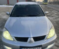 Сірий Міцубісі Lancer, об'ємом двигуна 1.58 л та пробігом 250 тис. км за 4100 $, фото 1 на Automoto.ua