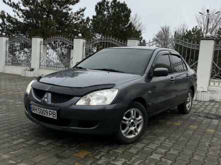 Серый Мицубиси Лансер, объемом двигателя 1.58 л и пробегом 320 тыс. км за 4150 $, фото 1 на Automoto.ua