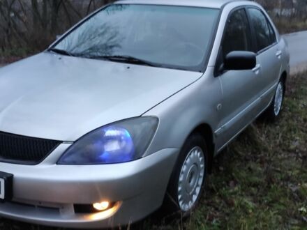 Серый Мицубиси Лансер, объемом двигателя 1.6 л и пробегом 235 тыс. км за 2850 $, фото 1 на Automoto.ua