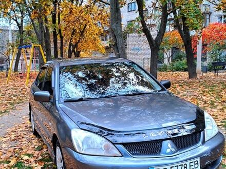 Серый Мицубиси Лансер, объемом двигателя 1.6 л и пробегом 206 тыс. км за 3300 $, фото 1 на Automoto.ua