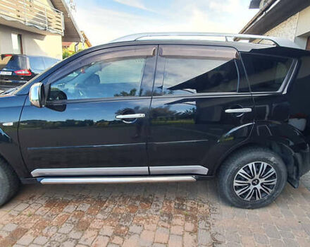 Черный Мицубиси Аутлендер ХЛ, объемом двигателя 2.4 л и пробегом 146 тыс. км за 10500 $, фото 1 на Automoto.ua