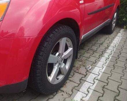 Красный Мицубиси Аутлендер ХЛ, объемом двигателя 2.4 л и пробегом 306 тыс. км за 10000 $, фото 1 на Automoto.ua