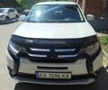 Белый Мицубиси Аутлендер, объемом двигателя 2.4 л и пробегом 142 тыс. км за 14550 $, фото 1 на Automoto.ua