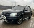 Черный Мицубиси Аутлендер, объемом двигателя 2.4 л и пробегом 244 тыс. км за 6800 $, фото 1 на Automoto.ua