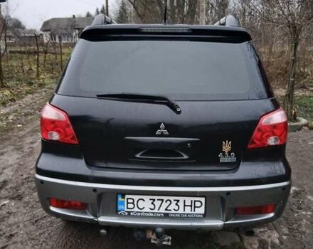 Черный Мицубиси Аутлендер, объемом двигателя 2 л и пробегом 395 тыс. км за 5200 $, фото 1 на Automoto.ua