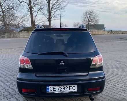 Чорний Міцубісі Аутлендер, об'ємом двигуна 2.38 л та пробігом 294 тис. км за 4550 $, фото 8 на Automoto.ua