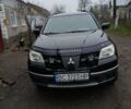 Черный Мицубиси Аутлендер, объемом двигателя 2 л и пробегом 395 тыс. км за 5200 $, фото 1 на Automoto.ua