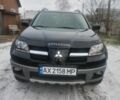 Черный Мицубиси Аутлендер, объемом двигателя 2.4 л и пробегом 150 тыс. км за 6300 $, фото 1 на Automoto.ua