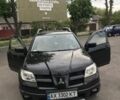 Черный Мицубиси Аутлендер, объемом двигателя 2 л и пробегом 213 тыс. км за 6200 $, фото 1 на Automoto.ua