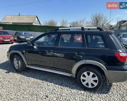 Черный Мицубиси Аутлендер, объемом двигателя 2.4 л и пробегом 204 тыс. км за 5390 $, фото 2 на Automoto.ua