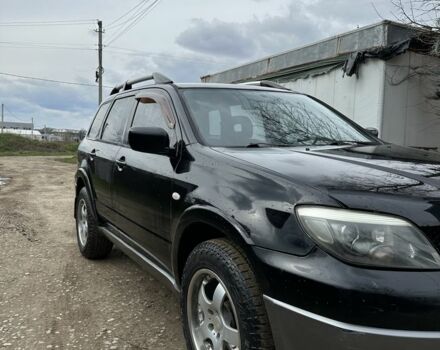 Черный Мицубиси Аутлендер, объемом двигателя 2.4 л и пробегом 258 тыс. км за 5400 $, фото 1 на Automoto.ua