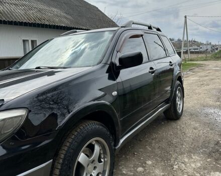 Черный Мицубиси Аутлендер, объемом двигателя 2.4 л и пробегом 258 тыс. км за 5400 $, фото 2 на Automoto.ua