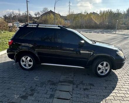 Черный Мицубиси Аутлендер, объемом двигателя 2.4 л и пробегом 307 тыс. км за 5600 $, фото 4 на Automoto.ua