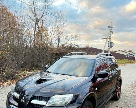 Черный Мицубиси Аутлендер, объемом двигателя 2 л и пробегом 295 тыс. км за 7500 $, фото 1 на Automoto.ua