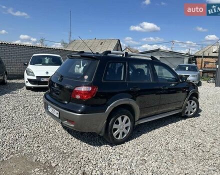 Черный Мицубиси Аутлендер, объемом двигателя 2.4 л и пробегом 204 тыс. км за 5390 $, фото 4 на Automoto.ua