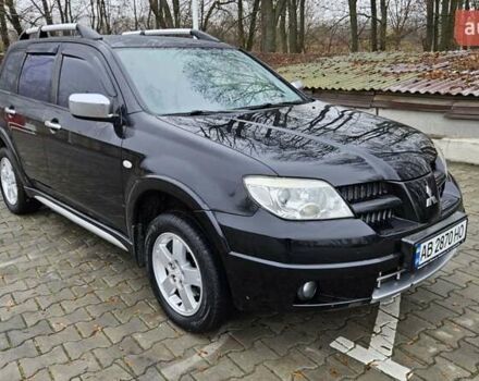 Черный Мицубиси Аутлендер, объемом двигателя 2.4 л и пробегом 167 тыс. км за 6150 $, фото 1 на Automoto.ua