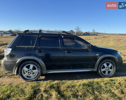 Черный Мицубиси Аутлендер, объемом двигателя 2.38 л и пробегом 230 тыс. км за 5350 $, фото 2 на Automoto.ua
