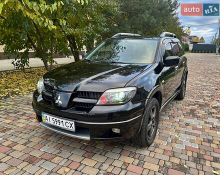 Чорний Міцубісі Аутлендер, об'ємом двигуна 2.38 л та пробігом 247 тис. км за 5499 $, фото 5 на Automoto.ua