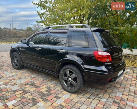 Чорний Міцубісі Аутлендер, об'ємом двигуна 2.38 л та пробігом 247 тис. км за 5499 $, фото 11 на Automoto.ua