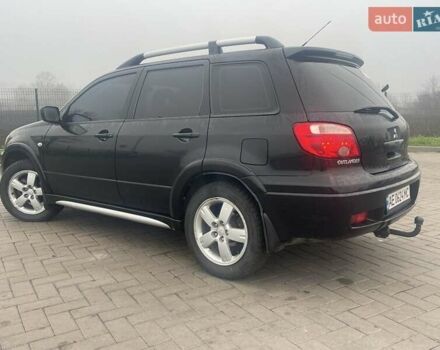 Черный Мицубиси Аутлендер, объемом двигателя 2.4 л и пробегом 277 тыс. км за 6700 $, фото 2 на Automoto.ua