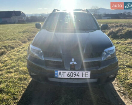 Черный Мицубиси Аутлендер, объемом двигателя 2.38 л и пробегом 230 тыс. км за 5350 $, фото 1 на Automoto.ua