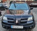 Черный Мицубиси Аутлендер, объемом двигателя 2.4 л и пробегом 265 тыс. км за 6100 $, фото 1 на Automoto.ua