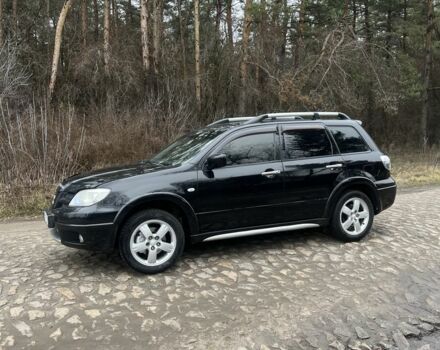 Черный Мицубиси Аутлендер, объемом двигателя 2.4 л и пробегом 310 тыс. км за 5300 $, фото 1 на Automoto.ua