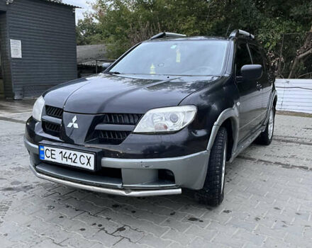 Черный Мицубиси Аутлендер, объемом двигателя 2 л и пробегом 280 тыс. км за 4999 $, фото 1 на Automoto.ua