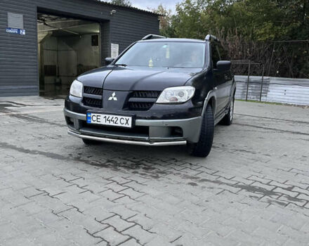 Черный Мицубиси Аутлендер, объемом двигателя 2 л и пробегом 280 тыс. км за 4999 $, фото 2 на Automoto.ua